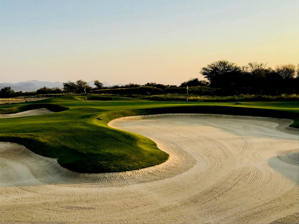 Image of a golf course with people playing golf
