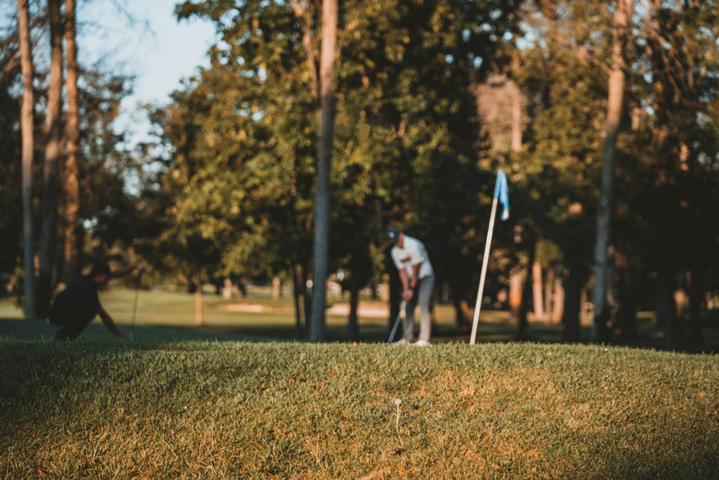 Image of a golf course with people playing golf