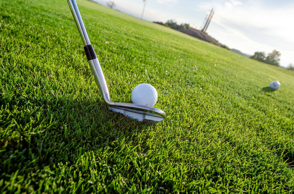Image of a golf course with people playing golf