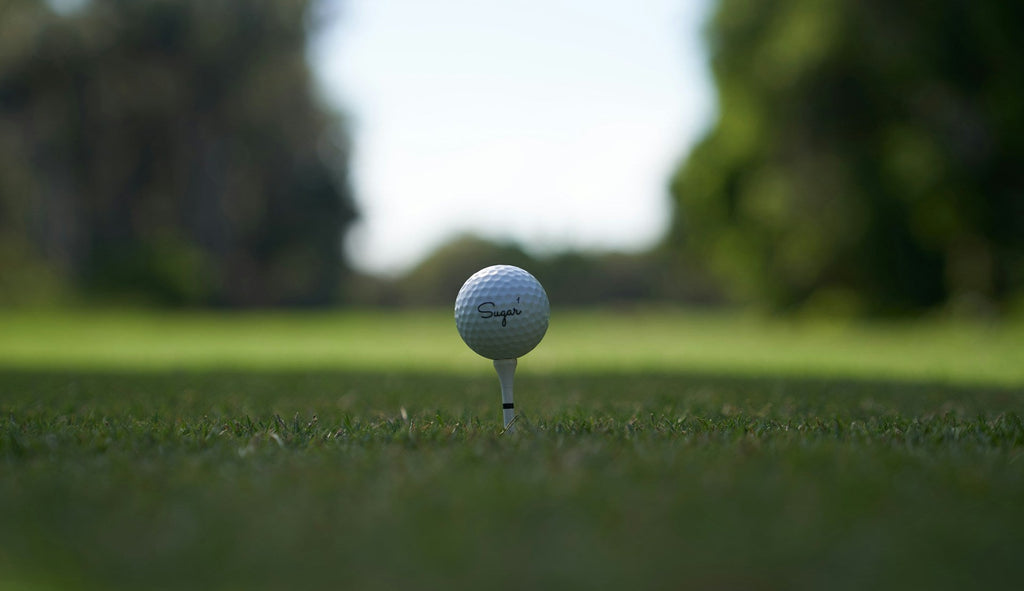 Image of a golf course with people playing golf