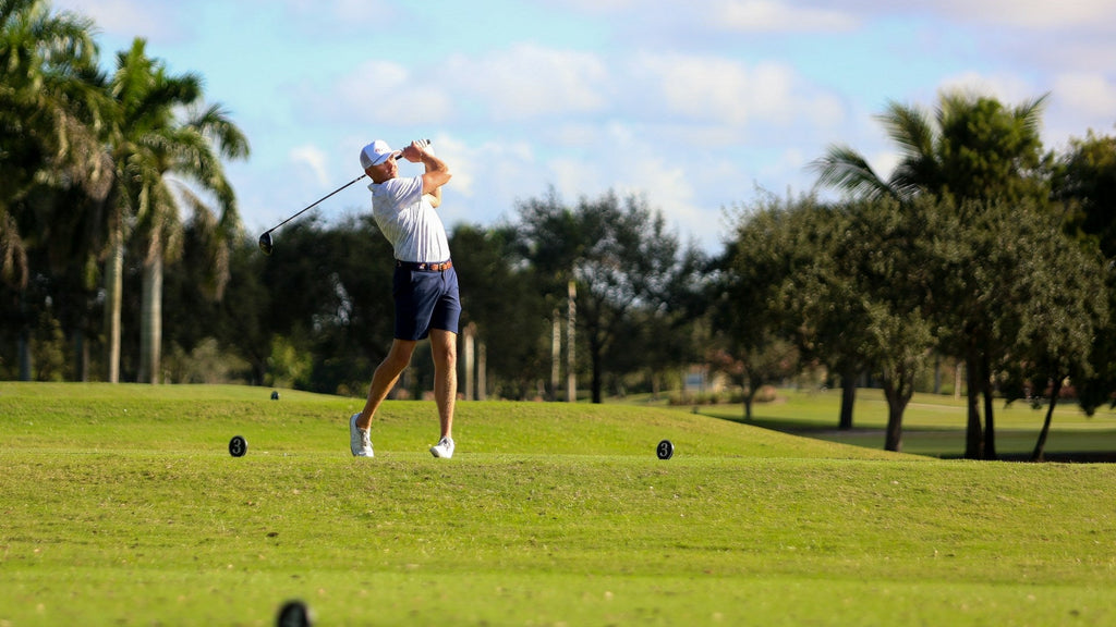 Image of a golf course with people playing golf